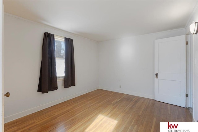 spare room with wood finished floors and baseboards