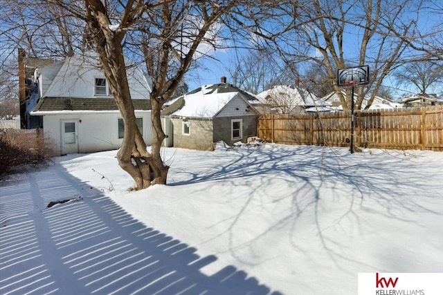 snowy yard with fence