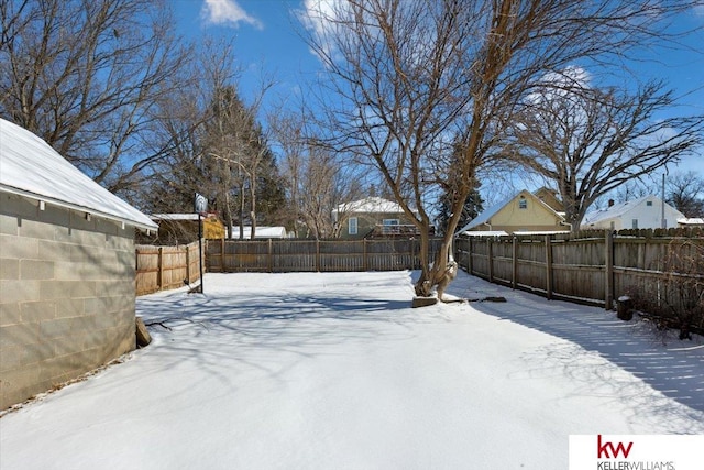 yard covered in snow featuring a fenced backyard