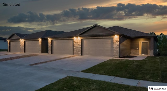 view of front facade with a garage, stone siding, and concrete driveway