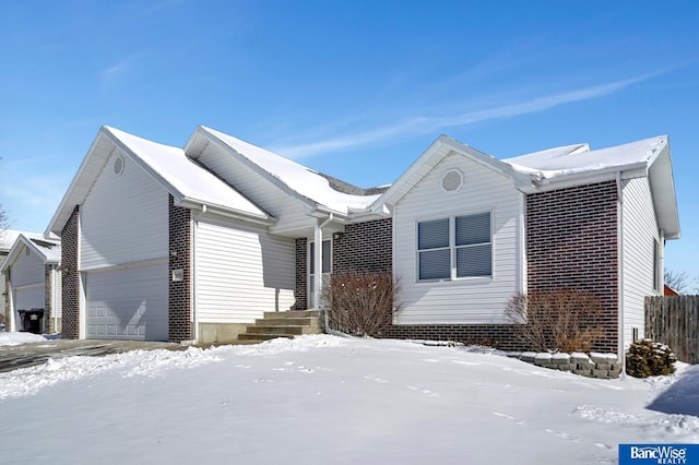 ranch-style house featuring brick siding and an attached garage