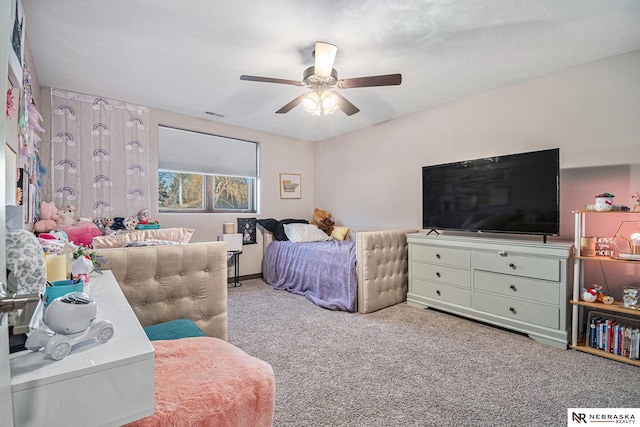 bedroom featuring visible vents, a ceiling fan, and light colored carpet