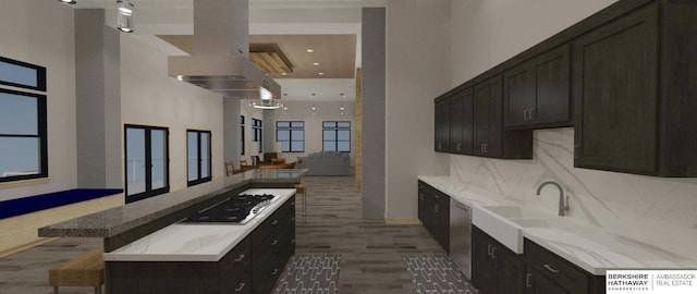 kitchen with gas stovetop, tasteful backsplash, a high ceiling, a sink, and dishwasher