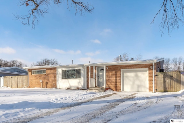 single story home with brick siding, fence, and an attached garage