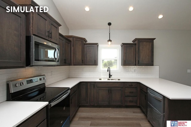 kitchen with stainless steel appliances, light countertops, a sink, and tasteful backsplash