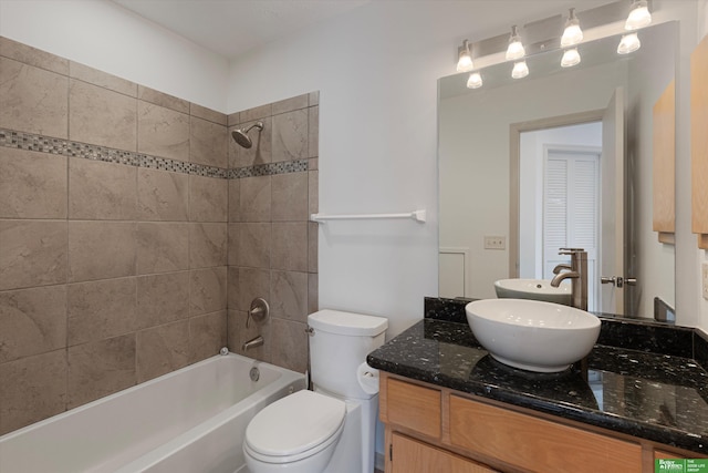 bathroom with shower / washtub combination, vanity, and toilet