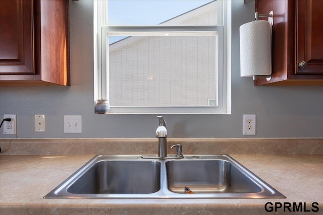 interior details featuring light countertops and a sink