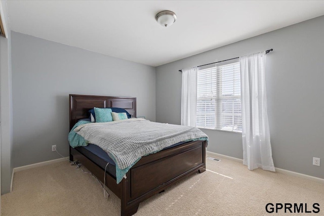 bedroom featuring visible vents, baseboards, and light colored carpet