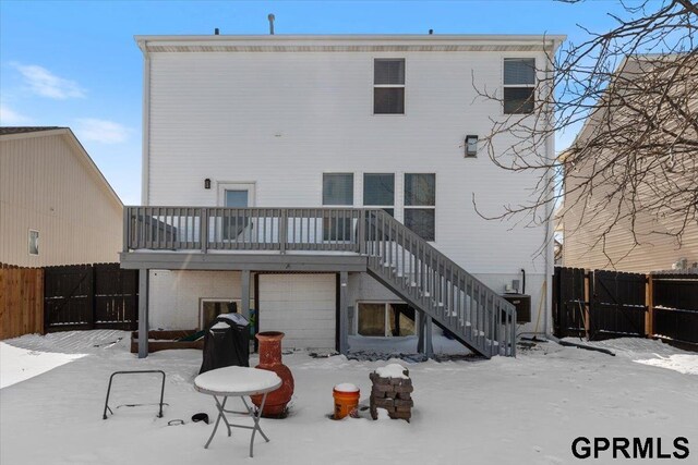 snow covered property with stairs and fence