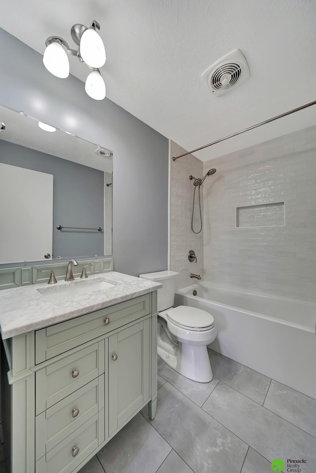 full bath featuring vanity, visible vents, bathtub / shower combination, a textured ceiling, and toilet