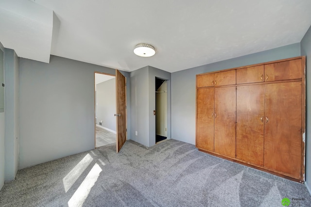 unfurnished bedroom featuring light carpet