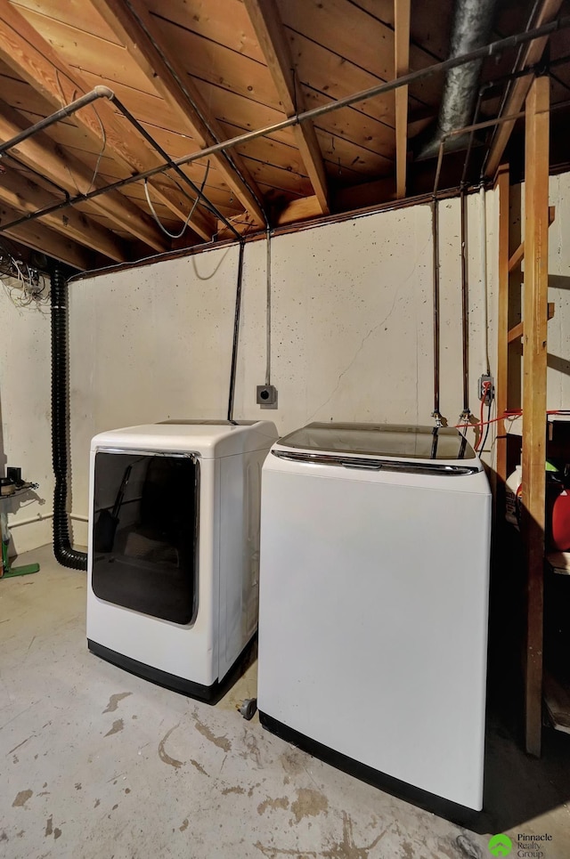 clothes washing area with laundry area and washer and clothes dryer