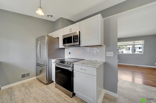 kitchen featuring white cabinetry, decorative backsplash, visible vents, and stainless steel appliances