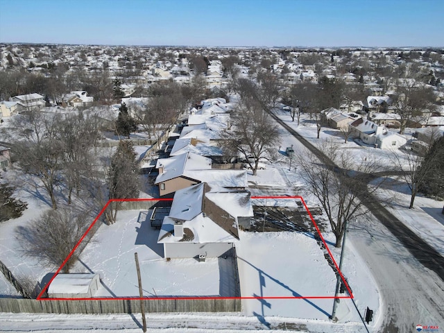 snowy aerial view with a residential view