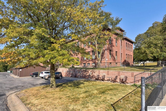 exterior space featuring fence and a front lawn