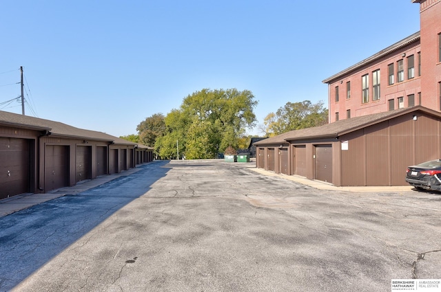 view of road featuring community garages