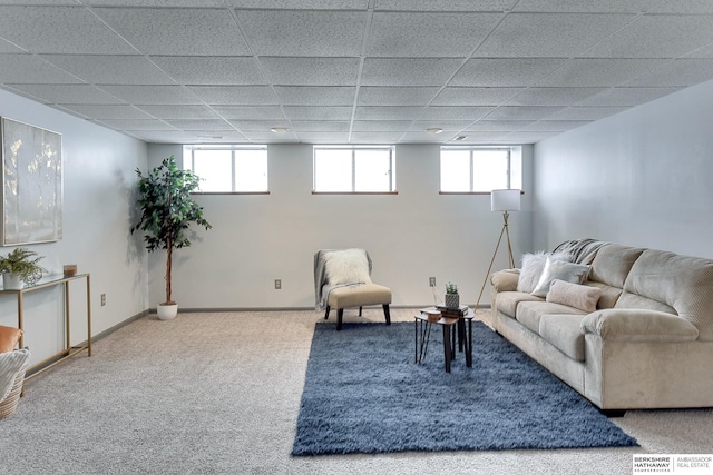 living room featuring a healthy amount of sunlight, carpet floors, and a paneled ceiling