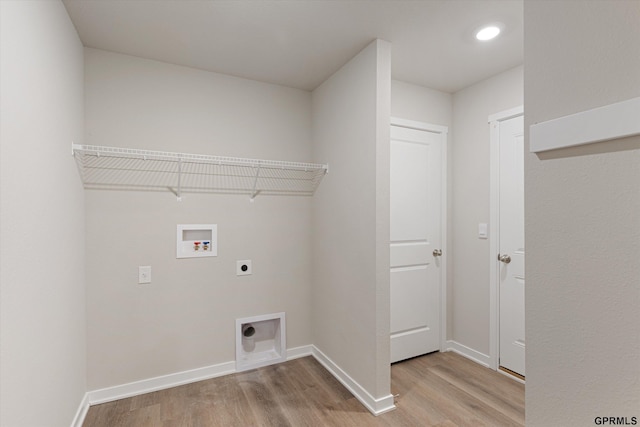 laundry room featuring hookup for a washing machine, laundry area, light wood finished floors, and hookup for an electric dryer