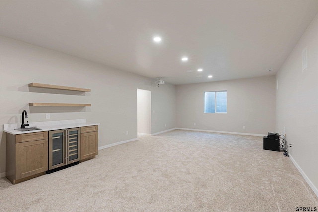 bar with recessed lighting, beverage cooler, light carpet, a sink, and baseboards