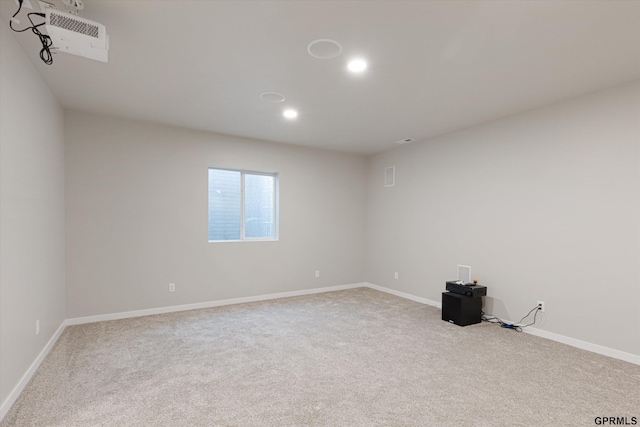 carpeted empty room featuring recessed lighting and baseboards