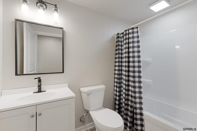 bathroom with toilet, shower / bath combo with shower curtain, and vanity