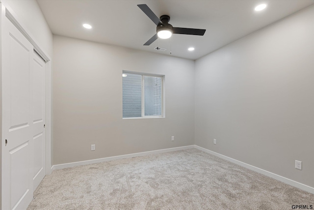 unfurnished room with light carpet, ceiling fan, baseboards, and recessed lighting