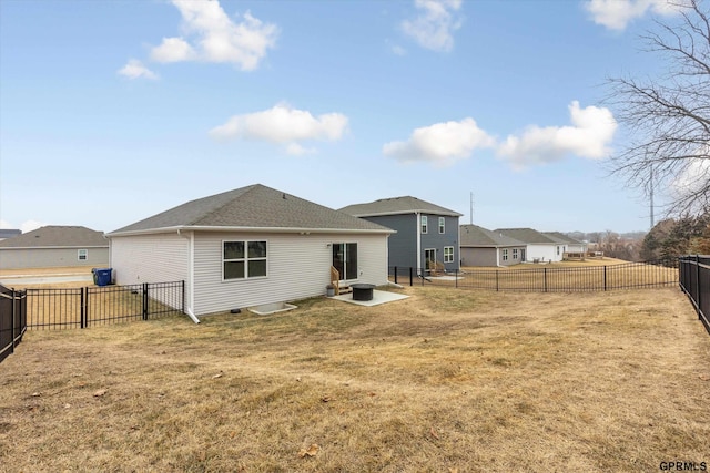 back of property featuring a residential view, a patio area, a fenced backyard, and a yard