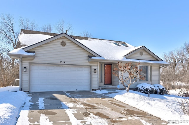 single story home with a garage and concrete driveway