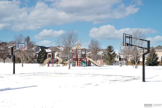 snow covered playground with community basketball court and playground community