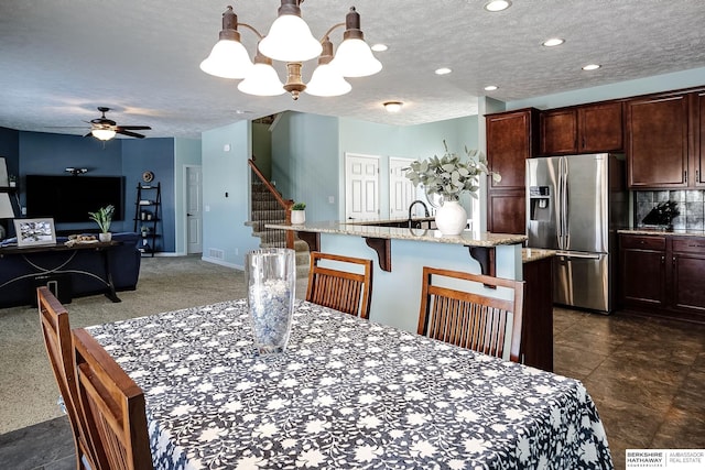 dining area with recessed lighting, visible vents, stairway, a textured ceiling, and ceiling fan with notable chandelier