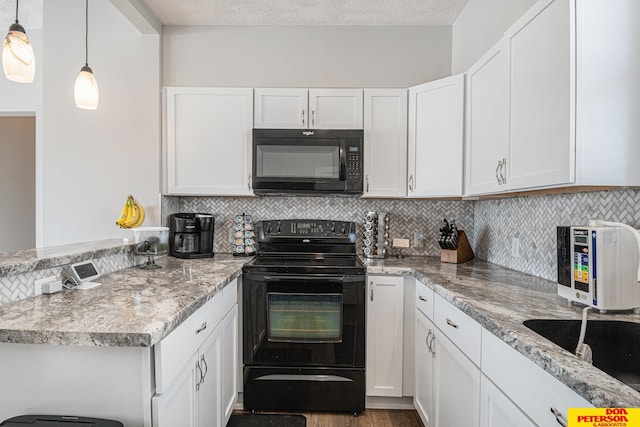 kitchen with hanging light fixtures, black appliances, tasteful backsplash, and white cabinets