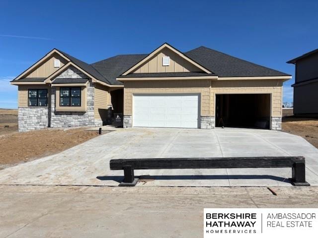 21802 Parkview Dr, Gretna, NE 68028 - craftsman-style home featuring stone siding, an attached garage, concrete driveway, and board and batten siding