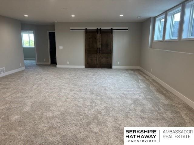 21802 Parkview Dr, Gretna, NE 68028 - unfurnished room with a barn door, light colored carpet, and recessed lighting