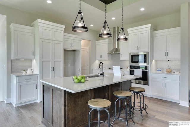 21802 Parkview Dr, Gretna, NE 68028 - kitchen featuring appliances with stainless steel finishes, light wood finished floors, decorative backsplash, recessed lighting, and white cabinets