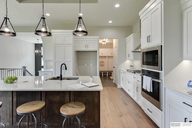 21802 Parkview Dr, Gretna, NE 68028 - kitchen with stainless steel appliances, recessed lighting, light wood-type flooring, light countertops, and white cabinets
