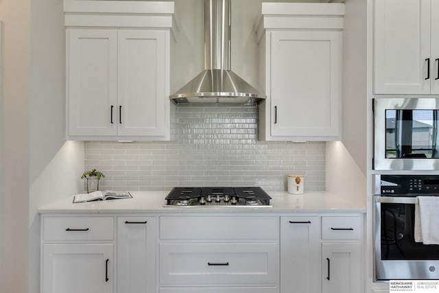 21802 Parkview Dr, Gretna, NE 68028 - kitchen featuring appliances with stainless steel finishes, wall chimney exhaust hood, white cabinets, backsplash, and light countertops