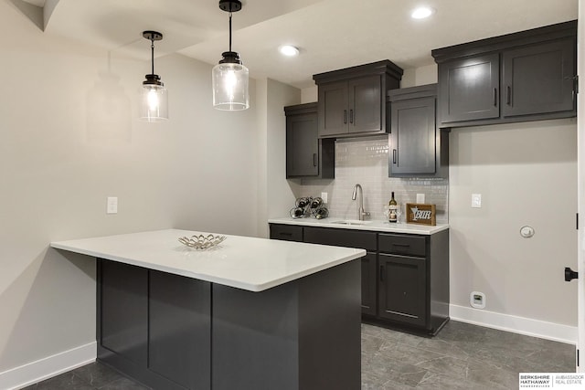 21802 Parkview Dr, Gretna, NE 68028 - kitchen featuring backsplash, a peninsula, light countertops, decorative light fixtures, and recessed lighting