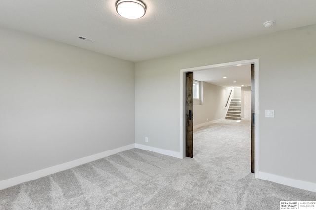 21802 Parkview Dr, Gretna, NE 68028 - unfurnished room featuring a smoke detector, light carpet, and stairs