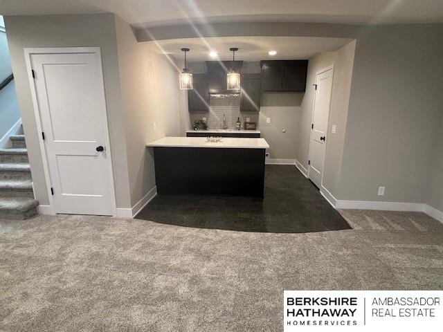 21802 Parkview Dr, Gretna, NE 68028 - kitchen featuring a peninsula, dark colored carpet, light countertops, tasteful backsplash, and decorative light fixtures