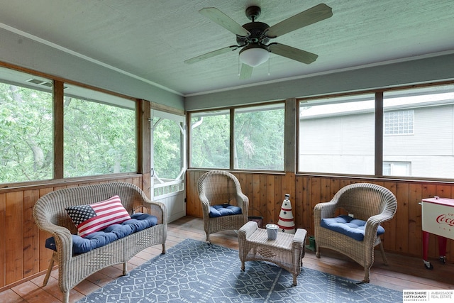 sunroom / solarium with a ceiling fan