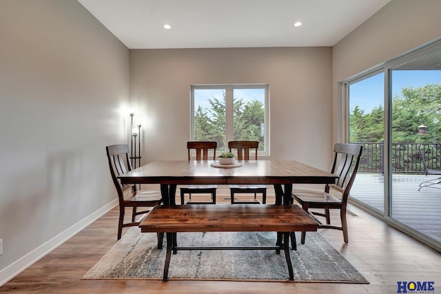 dining room featuring light wood-style floors, recessed lighting, and baseboards