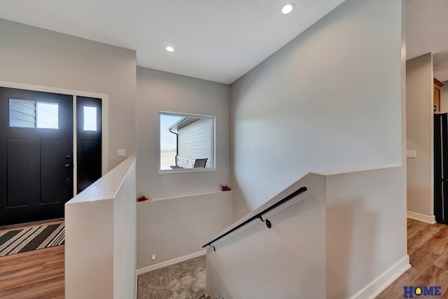 interior space with light wood-type flooring, recessed lighting, and baseboards