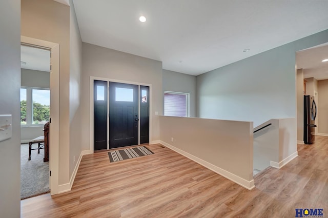 entrance foyer with light wood-style floors, recessed lighting, and baseboards