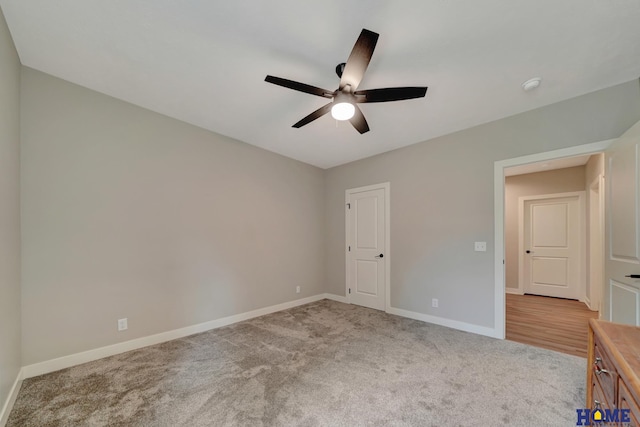 unfurnished bedroom featuring baseboards, ceiling fan, and light colored carpet