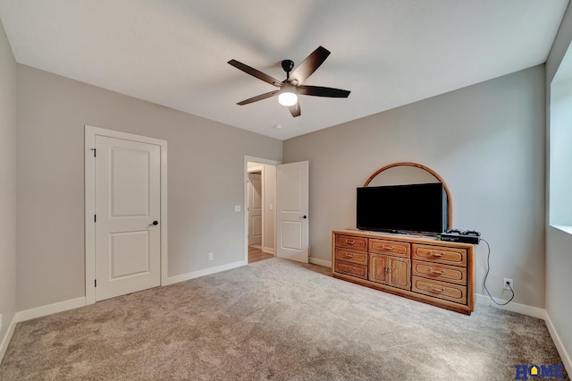 unfurnished bedroom featuring baseboards, a ceiling fan, and light colored carpet