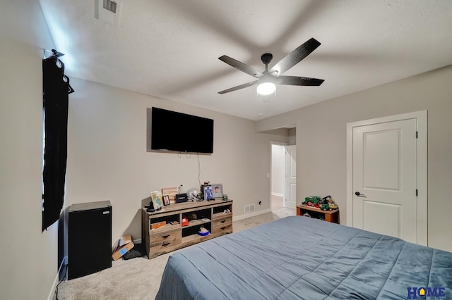 carpeted bedroom with a ceiling fan and baseboards