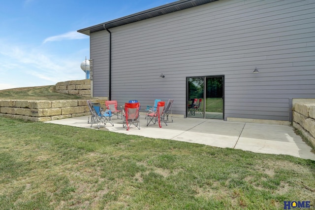 exterior space with a patio area and a lawn