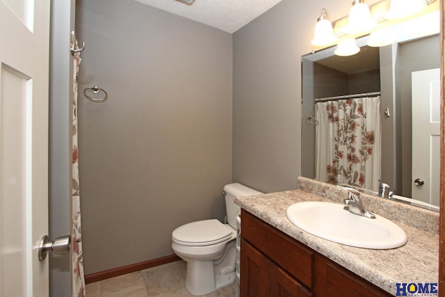 full bathroom featuring toilet, vanity, and baseboards