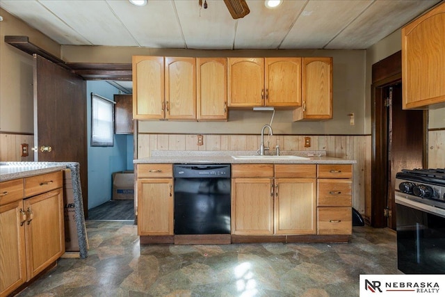 kitchen with wood walls, a sink, light countertops, dishwasher, and range with gas cooktop