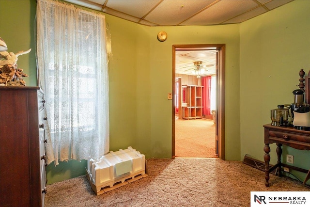 miscellaneous room featuring a paneled ceiling and carpet flooring